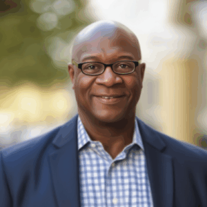 A professional portrait of Groundswell COO D.A. Abrams. D.A. Abrams is shown in business attire, smiling warmly and exuding confidence and approachability. The clean background keeps the focus on his leadership presence and executive role.