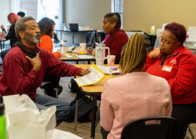 Volunteers discuss initiatives in heir community at an event similar to those hosted through Illinois Community Solar Energy Sovereignty efforts